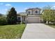 Inviting two-story home with a well-manicured lawn and a spacious driveway leading to a two-car garage at 4713 S Ireland St, Aurora, CO 80015