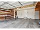 Spacious two-car garage with finished wood paneling and painted floor at 4713 S Ireland St, Aurora, CO 80015
