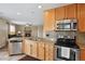 Well-equipped kitchen with stainless steel appliances and granite countertops, seamlessly connecting to the living area at 4713 S Ireland St, Aurora, CO 80015