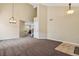 Open living area with high ceilings, neutral carpet, and view into adjacent room at 4713 S Ireland St, Aurora, CO 80015