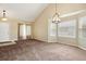 Bright living room featuring neutral carpet, vaulted ceiling, and ample natural light streaming through large windows at 4713 S Ireland St, Aurora, CO 80015