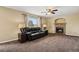 Inviting living room featuring a brick fireplace, neutral carpet, and comfortable seating at 4713 S Ireland St, Aurora, CO 80015