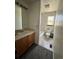 Bathroom with a bath and shower combo, ceramic tile floor, and vanity sink at 780 2Nd St, Bennett, CO 80102