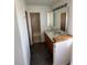Bathroom featuring a vanity and a tiled shower at 780 2Nd St, Bennett, CO 80102
