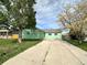 A charming single-story green home with a long driveway and front yard at 780 2Nd St, Bennett, CO 80102