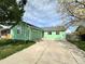 A charming single-story green home with an attached garage and front yard at 780 2Nd St, Bennett, CO 80102