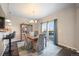 Dining area with hardwood floors, access to deck, and kitchen view at 9066 Sandpiper Dr, Frederick, CO 80504