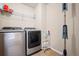 Bright laundry room, featuring a washer, dryer, and ample shelving at 9066 Sandpiper Dr, Frederick, CO 80504