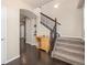 Elegant staircase with wrought-iron railing and hardwood floors at 9066 Sandpiper Dr, Frederick, CO 80504