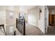 Upper hallway with carpet and access to a private balcony at 9066 Sandpiper Dr, Frederick, CO 80504