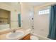 Bright bathroom with a combined tub and shower, adjacent to a laundry area at 5255 Memphis St # 315, Denver, CO 80239