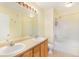 Clean bathroom with a double sink vanity, soaking tub, and tiled shower at 5255 Memphis St # 315, Denver, CO 80239