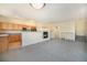 Spacious open floor plan with a fireplace, modern kitchen, and staircase at 5255 Memphis St # 315, Denver, CO 80239
