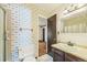 Full bathroom with vintage tile, vanity, and wallpaper with shower at 4445 S Lowell Blvd, Denver, CO 80236