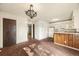 Bright dining room with laminate flooring, updated appliances, and classic chandelier at 4445 S Lowell Blvd, Denver, CO 80236