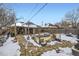 Backyard with flagstone patio, garden area, and snow at 543 S Bryant St, Denver, CO 80219