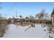 Snowy backyard with garden beds and storage shed at 543 S Bryant St, Denver, CO 80219