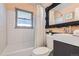 Clean bathroom with white tile, modern vanity, and ornate mirror at 543 S Bryant St, Denver, CO 80219