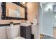 Small bathroom with pedestal sink, toilet, and ornate mirror at 543 S Bryant St, Denver, CO 80219