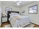 Cozy bedroom with a queen bed and built-in headboard, ceiling fan at 543 S Bryant St, Denver, CO 80219