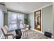 Charming dining area with glass table and modern chairs near sliding glass doors at 543 S Bryant St, Denver, CO 80219