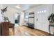 Entryway with hardwood floors, coat rack, and view into kitchen at 543 S Bryant St, Denver, CO 80219