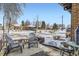 Cozy patio furniture on snowy patio with neighborhood view at 543 S Bryant St, Denver, CO 80219