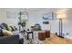 Living room with hardwood floors, gray couch, and green accent chair at 543 S Bryant St, Denver, CO 80219