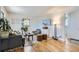 Living room with hardwood floors, gray couch, and green accent chair at 543 S Bryant St, Denver, CO 80219