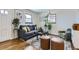 Living room with hardwood floors, gray couch, and green accent chair at 543 S Bryant St, Denver, CO 80219