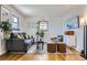 Bright living room with hardwood floors, comfortable seating, and stylish decor at 543 S Bryant St, Denver, CO 80219