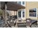 Covered deck with pergola, comfortable seating area, and adjacent to the house at 8656 Aberdeen Cir, Highlands Ranch, CO 80130