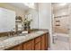 Well-appointed bathroom with double sinks and shower/tub combo at 8656 Aberdeen Cir, Highlands Ranch, CO 80130