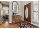 Bright entryway with hardwood floors, mirror, and storage console at 8656 Aberdeen Cir, Highlands Ranch, CO 80130