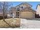 Two-story house with stone accents, attached garage, and manicured lawn at 8656 Aberdeen Cir, Highlands Ranch, CO 80130