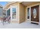 Inviting front porch with seating area and a wood door at 8656 Aberdeen Cir, Highlands Ranch, CO 80130