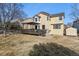 Two-story house with solar panels, deck, and storage shed in the backyard at 8656 Aberdeen Cir, Highlands Ranch, CO 80130