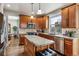 Kitchen features an island, wood cabinets, and stainless steel appliances at 8656 Aberdeen Cir, Highlands Ranch, CO 80130