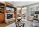 Living room boasts a stone fireplace and built-in shelving at 8656 Aberdeen Cir, Highlands Ranch, CO 80130