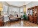 Spacious living room with hardwood floors, bay window, and comfy seating at 8656 Aberdeen Cir, Highlands Ranch, CO 80130