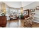 Spacious living room with hardwood floors, bay window, and comfy seating at 8656 Aberdeen Cir, Highlands Ranch, CO 80130