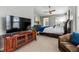 Main bedroom with a large TV and ample space for furniture at 8656 Aberdeen Cir, Highlands Ranch, CO 80130