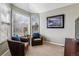 Cozy sitting area with comfortable armchairs and large windows at 8656 Aberdeen Cir, Highlands Ranch, CO 80130