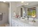 Bright bathroom with a white vanity, large mirror, window and decorative fixtures at 455 Greenwood, Longmont, CO 80504