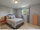 Neutral bedroom featuring light gray walls, plush bedding, and a window with natural light at 455 Greenwood, Longmont, CO 80504