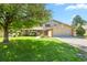 Charming two-story home featuring a well-manicured lawn, mature shade trees, and a two-car garage at 455 Greenwood, Longmont, CO 80504