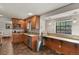 Well-lit kitchen featuring wood cabinetry, granite countertops, and a stainless steel dishwasher at 455 Greenwood, Longmont, CO 80504