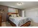 A calming main bedroom with a wood bed frame, soft lighting, a closet, and decorative mirrors at 455 Greenwood, Longmont, CO 80504