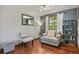 Cozy sitting room with hardwood floors, a comfortable armchair, and decorative shelving at 455 Greenwood, Longmont, CO 80504