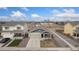Aerial view of a home featuring a driveway, landscaping, and a well-manicured lawn at 47341 Lily Ave, Bennett, CO 80102